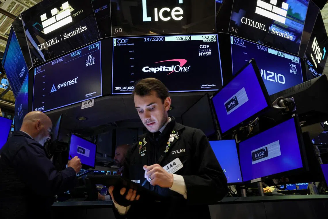 Traders work on the floor at the New York Stock Exchange, in New York City.
