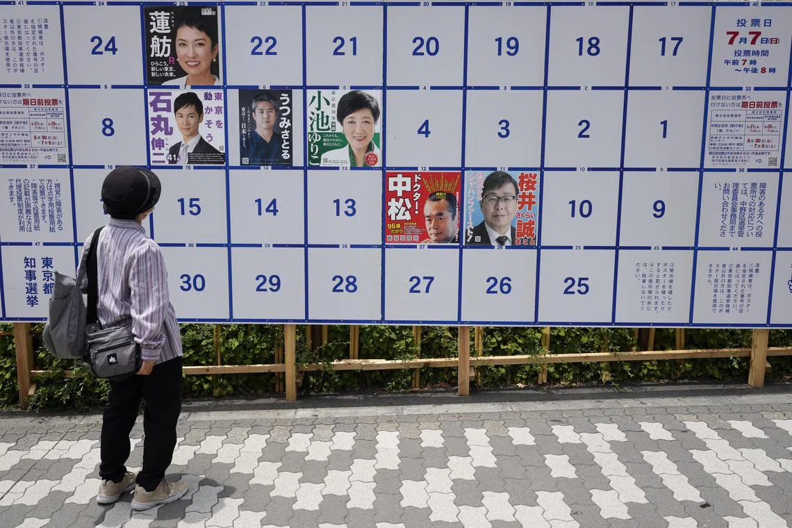 epa11424397 A passerby looks at a board displaying campaign posters of candidates running for the upcoming Tokyo gubernatorial election in Tokyo, Japan, 20 June 2024. The official campaigning for the Tokyo gubernatorial election kicked off on 20 June as incumbent Yuriko Koike is aiming for a third four-year term. Koike has the support of the ruling bloc and is challenged by the main opposition-backed politician Renho. A record 56 people had registered to run for the election that will be held on 07 July 2024 to elect the new governor of Tokyo.  EPA-EFE/FRANCK ROBICHON