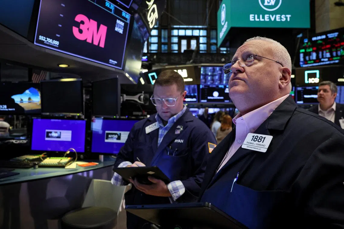 Traders work on the floor of the New York Stock Exchange, in New York City.