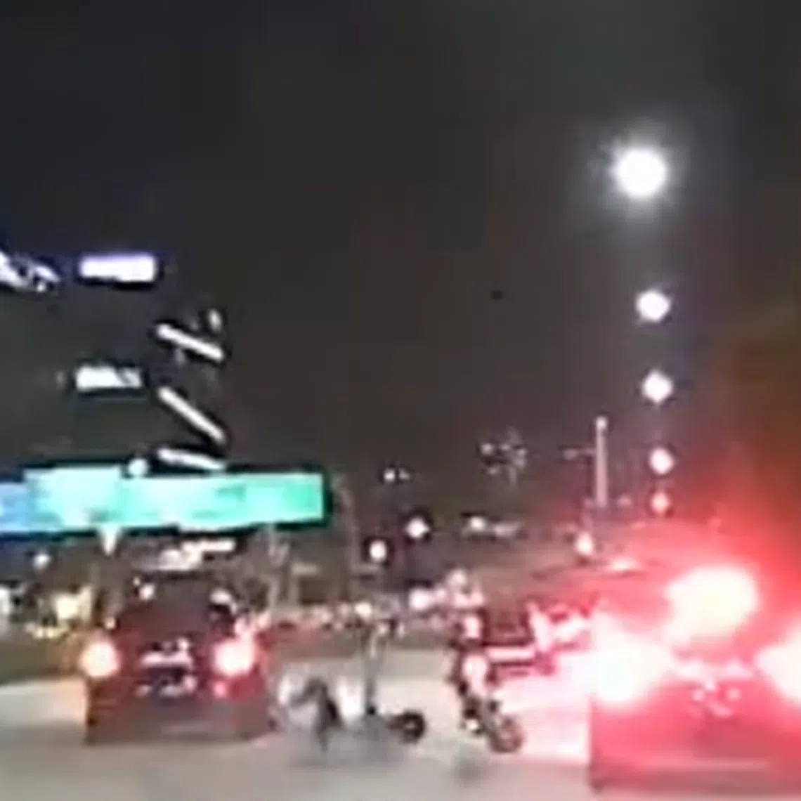 A video posted on Facebook shows a dark-coloured car driving next to a motorcycle.