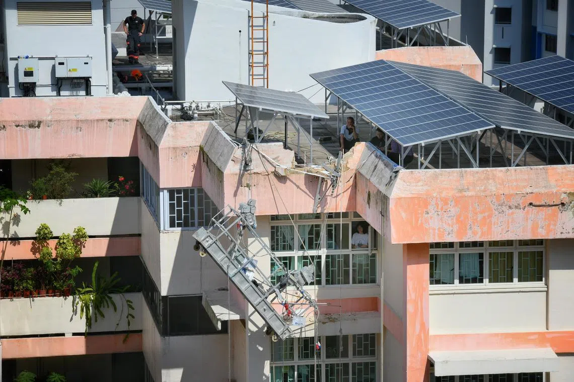Gondola gives way after part of HDB roof parapet in Boon Lay collapses.