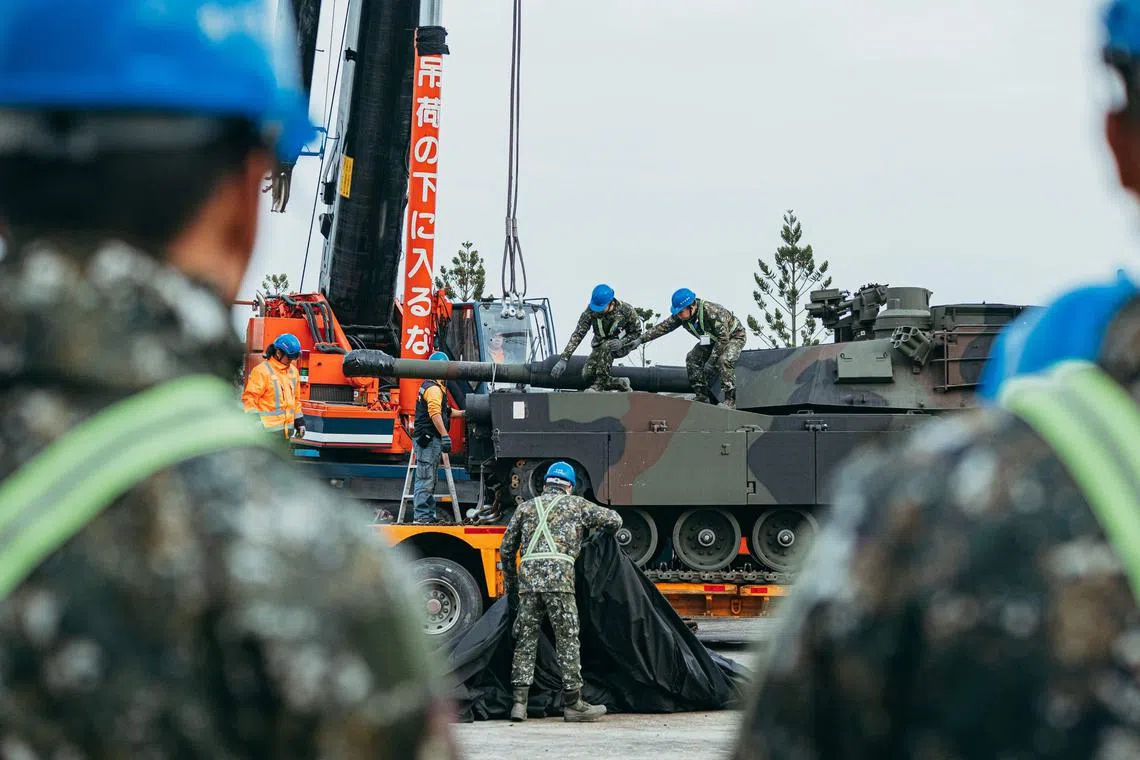 This handout photo taken and released on Dec 16 by Taiwan's defence ministry shows soldiers securing a US-made M1A2 Abrams battle tank onto a trailer at an army armour training centre in Hsinchu County. Taiwan received 38 advanced Abrams battle tanks from the United States.