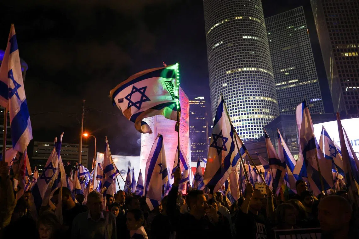 People take part in a demonstration against Israeli Prime Minister Benjamin Netanyahu and his nationalist coalition government's plan for judicial overhaul, in Tel Aviv, Israel April 1, 2023. REUTERS/Ronen Zvulun