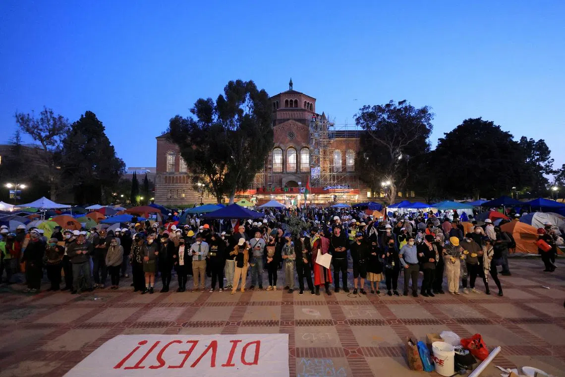FILE PHOTO: Members of UCLA faculty stand on the frontlines as protesters stand together in the encampment after they were asked to leave by UCLA campus police, during a protest in support of Palestinians in Gaza, at the University of California Los Angeles (UCLA), as the conflict between Israel and the Palestinian Islamist group Hamas continues, in Los Angeles, California, U.S., May 1, 2024. REUTERS/David Swanson/File Photo
