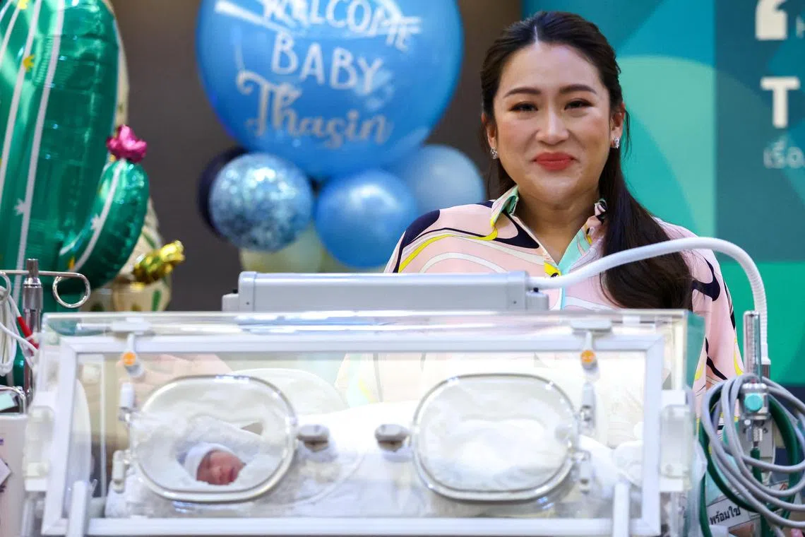 Pheu Thai's leading prime ministerial candidate, Paetongtarn Shinawatra, daughter of former Prime Minister Thaksin Shinawatra, standsing next to an incubator containing her newborn baby Prutthasin Sooksawas, during a news conference in Bangkok, Thailand, on May 3, 2023. 