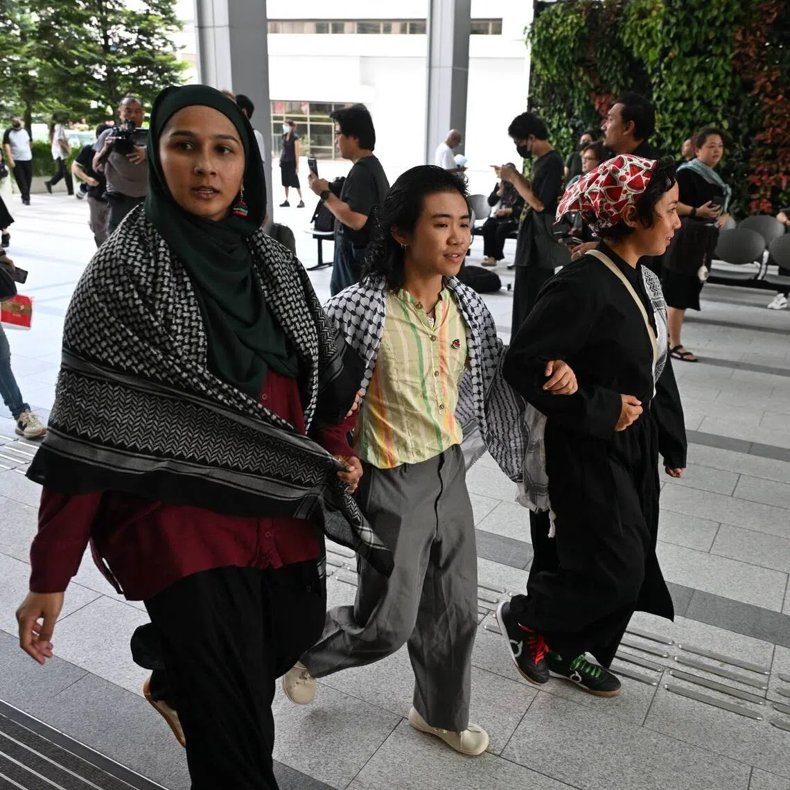 (From left) Dayana Noor Mohamed, Elijah Tay and Amirah Binti Mokhlis arriving at the State Courts on Sept 9.