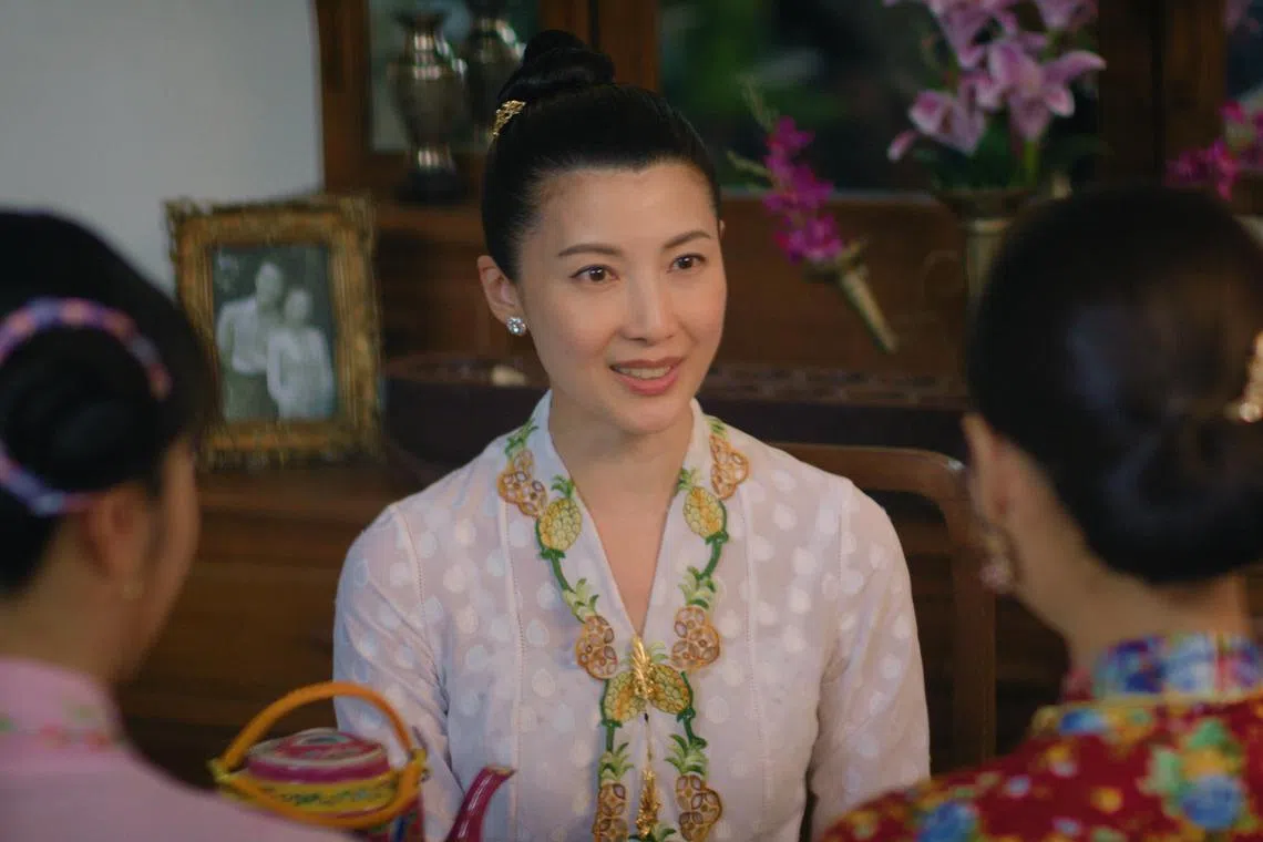 Actress Jeanette Aw wears a kebaya embellished with pineapple embroidery in Emerald Hill – The Little Nyonya Story.
