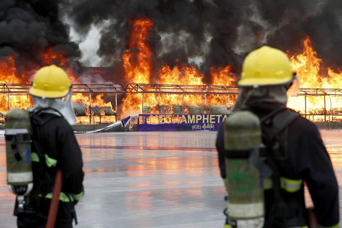 epa10711590 Firefighters standby near a burning pile of illegal drugs during a 'Destruction Ceremony of Seized Narcotic Drugs' held to mark the International Day Against Drug Abuse and Illicit Trafficking, in Yangon, Myanmar, 26 June 2023. Myanmar authorities destroyed an assortment of drugs worth over 446 million dollars all over the country.  EPA-EFE/NYEIN CHAN NAING