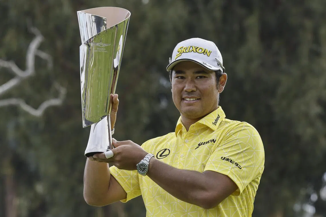 Hideki Matsuyama of Japan holding up the championship trophy after winning the Genesis Invitational at Riviera Country Club in Los Angeles.