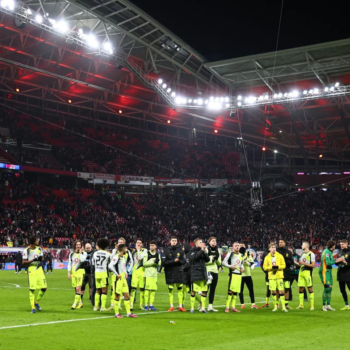 Soccer Football - Bundesliga - RB Leipzig v Borussia Dortmund - Red Bull Arena, Leipzig, Germany - February 21, 2026 Borussia Dortmund players applaud fans after the match REUTERS/Karina Hessland