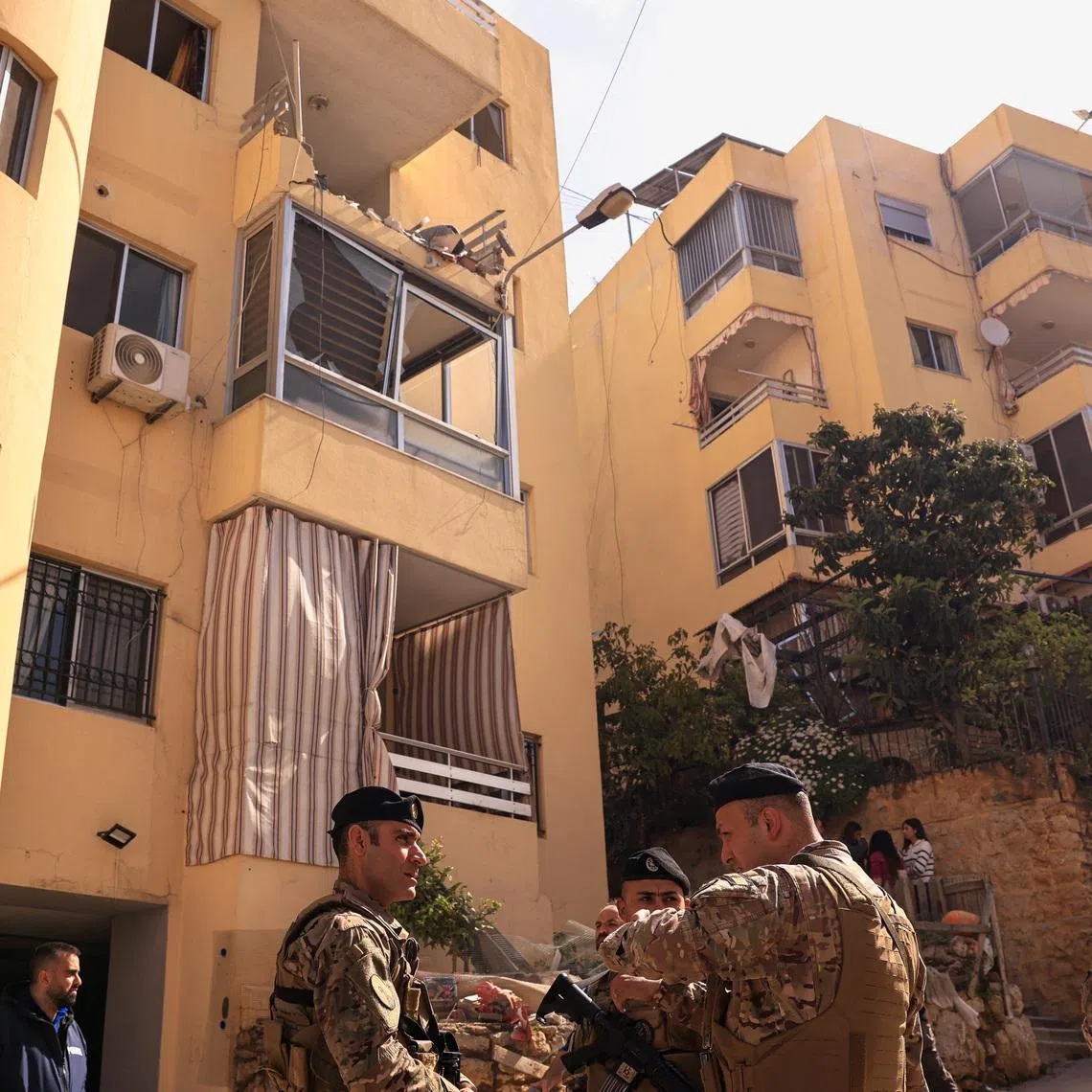 Lebanese Army servicemen stand near an apartment building hit by an Israeli strike amid escalating hostilities between Israel and Hezbollah, as the U.S.-Israel conflict with Iran continues, in Ain Saadeh, Lebanon, April 6, 2026.