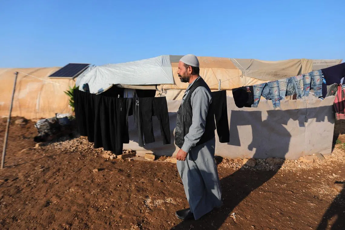 Displaced Syrian Mohammed Abu Ali looks on near his tent at a camp in the Sandaf area held by Turkey-backed forces. Syria's grinding conflict has already uprooted many Syrian families several times, but now they fear a threatened Turkish offensive will force them to flee the muddy displacement camp they call home. 