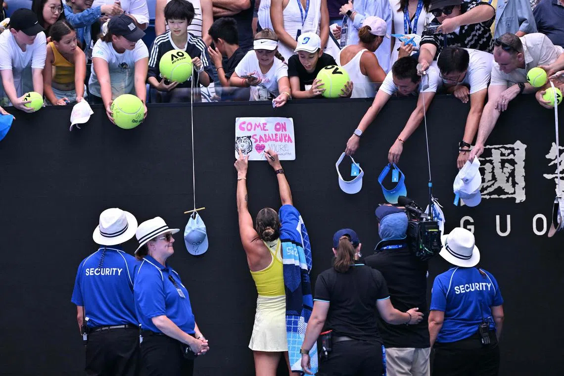 Belarus' Aryna Sabalenka signs autographs after beating Russia's Mirra Andreeva in their women's singles match at the Australian Open.