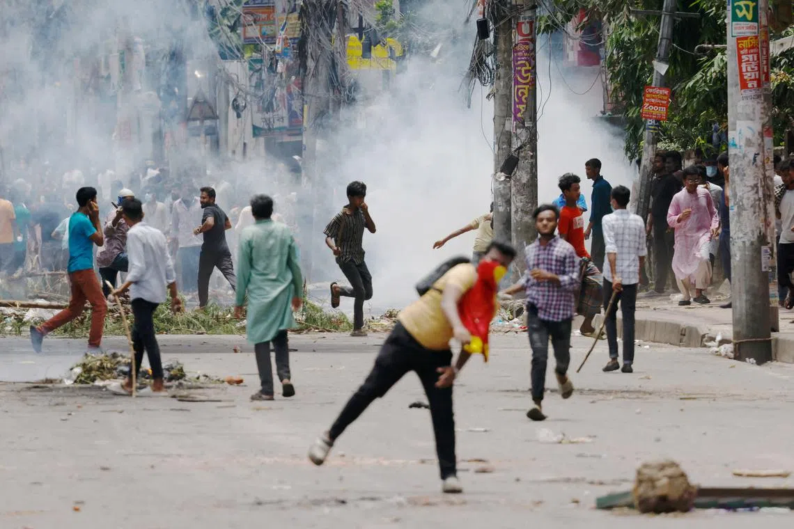 Protesters clash with police outside the state-owned Bangladesh Television,as violence erupts across the country, in Dhaka, on July 19.