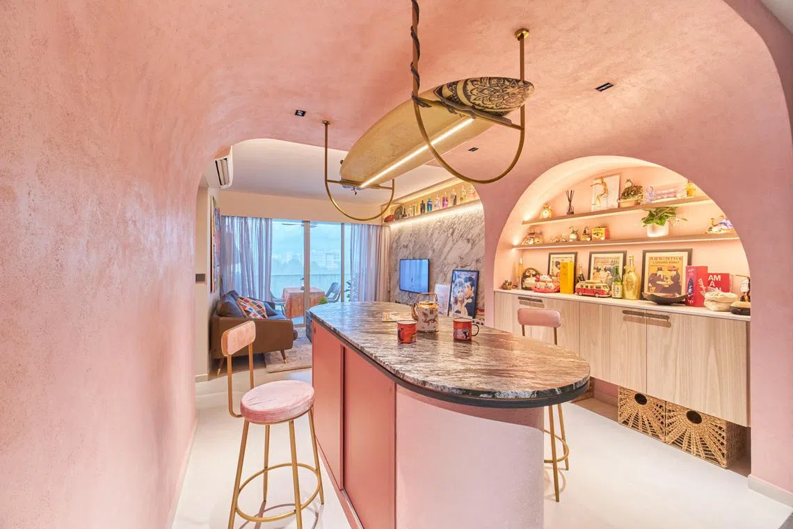 Conceived as a cave that has a pinkish stucco wall and ceiling finish, this area has a nook built into a wall to accommodate the couple's collection of holiday souvenirs, collectible figurines and limited edition liquor bottles. Leon Luo's surfboard also hangs from the ceiling on a special light fixture that he designed.