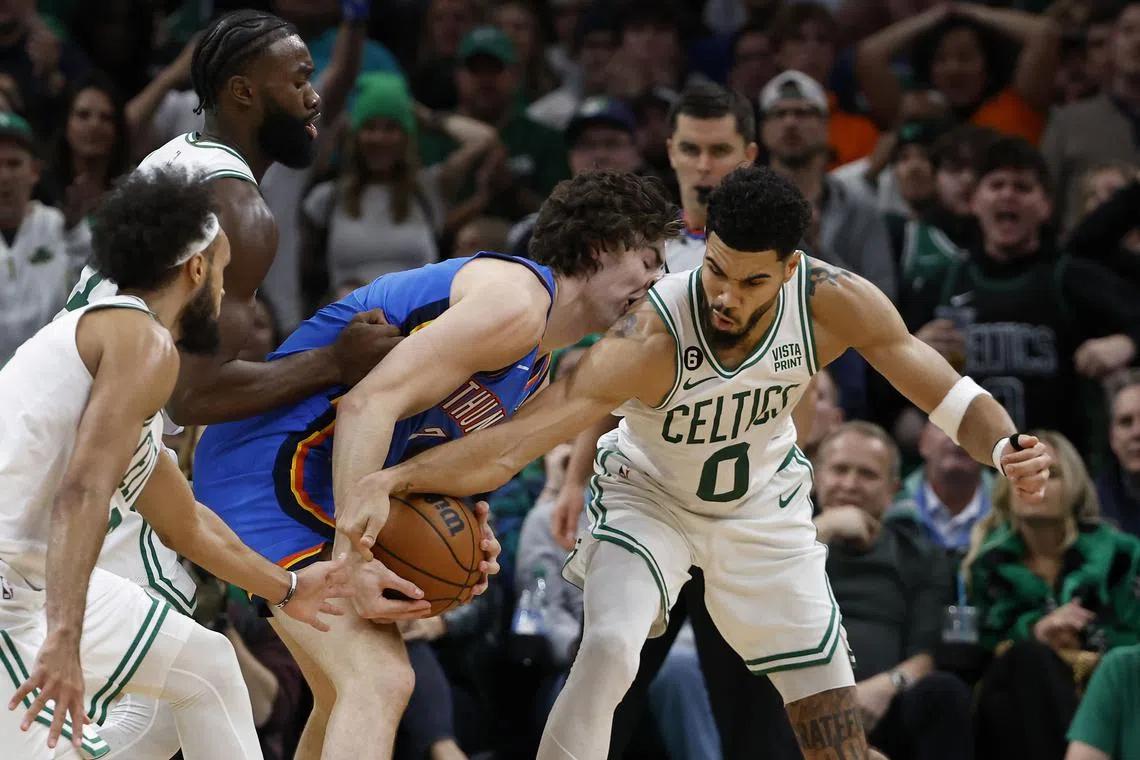 Jayson Tatum (No. 0) of the Boston Celtics tries to steal the ball from Oklahoma City Thunder's Josh Giddey during their NBA clash at the at TD Garden on Nov 14.
