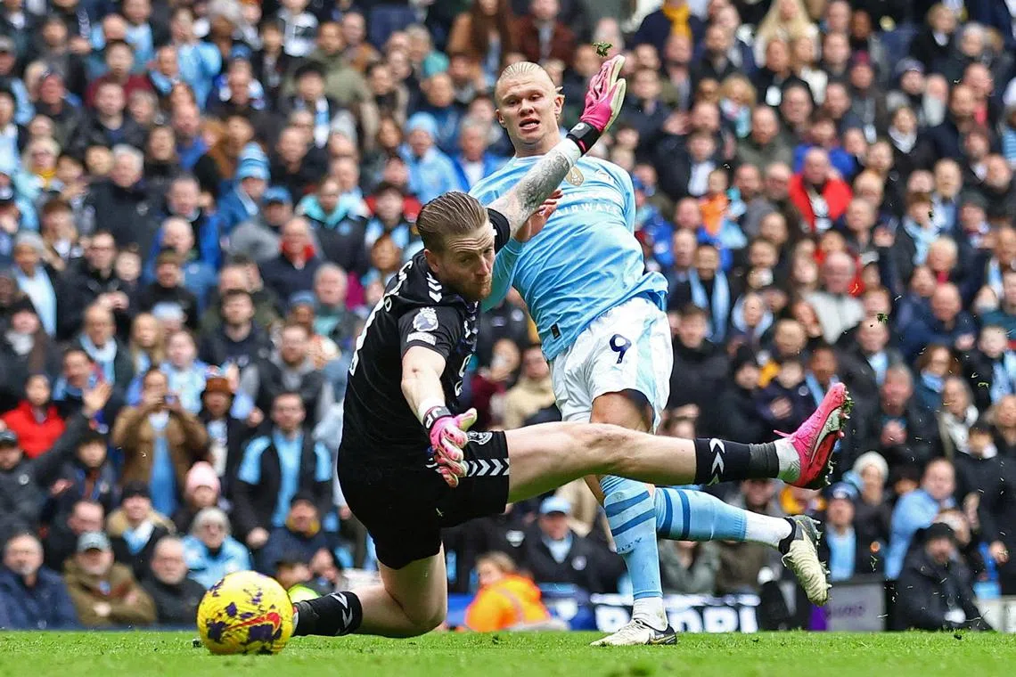 Manchester City's Erling Haaland scores their second goal past Everton's Jordan Pickford.