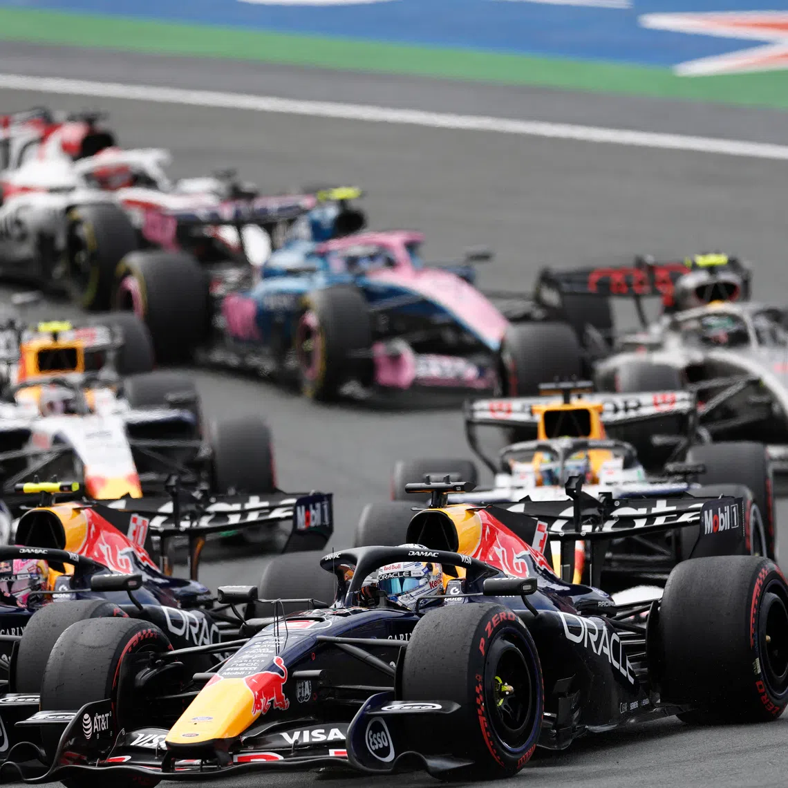 Formula One F1 - Dutch Grand Prix - Circuit Zandvoort, Zandvoort, Netherlands - August 23, 2026 Red Bull's Max Verstappen and Liam Lawson in action at the start of the race REUTERS/Benoit Tessier