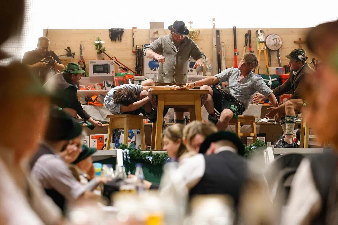 Competitors face off during the 70th Bavarian finger wrestling (Fingerhakeln) championships in Mittenwald on August 31, 2025, southern Germany. (Photo by Michaela STACHE / AFP)