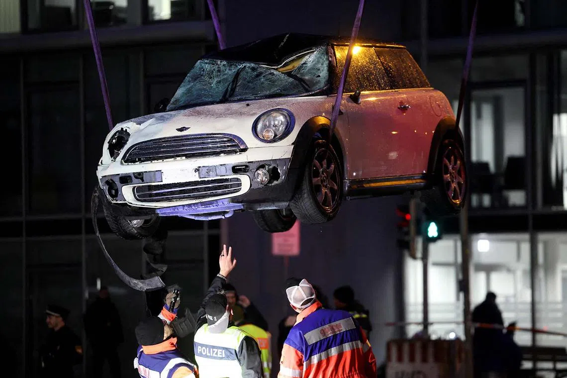 The car used by an Afghan asylum seeker being removed from a street, after plowing into a crowd in Munich, Germany and injuring some 28 people on Feb 13, 2025. 