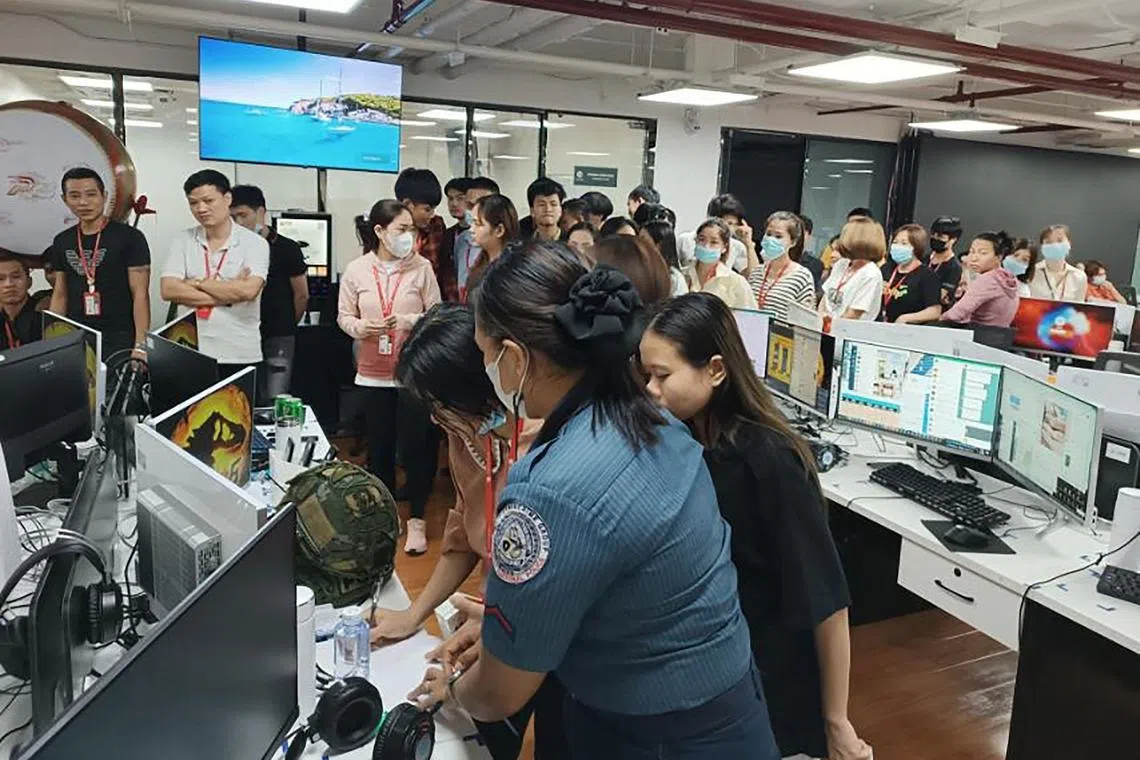 Rescued trafficking victims waiting to be documented by Philippine authorities after a police raid inside a freeport zone in Mabalacat City on May 4.