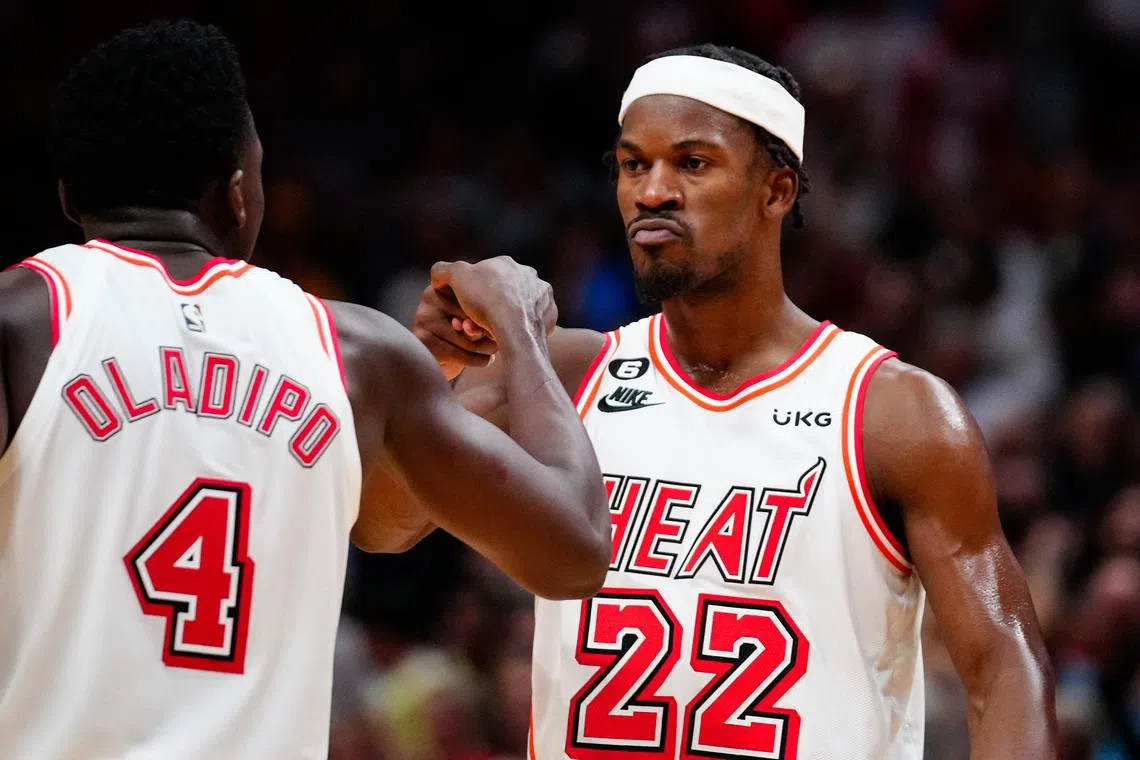 Miami Heat forward Jimmy Butler (No. 22) celebrates with guard Victor Oladipo after scoring against the Oklahoma City Thunder on Tuesday. 