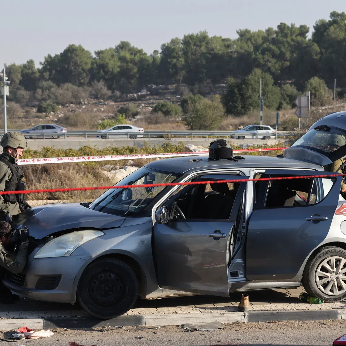 Israeli security forces inspecting a vehicle at the site of a reported ramming and stabbing attack in the area of Gush Etzion Junction in the West Bank on Nov 18.