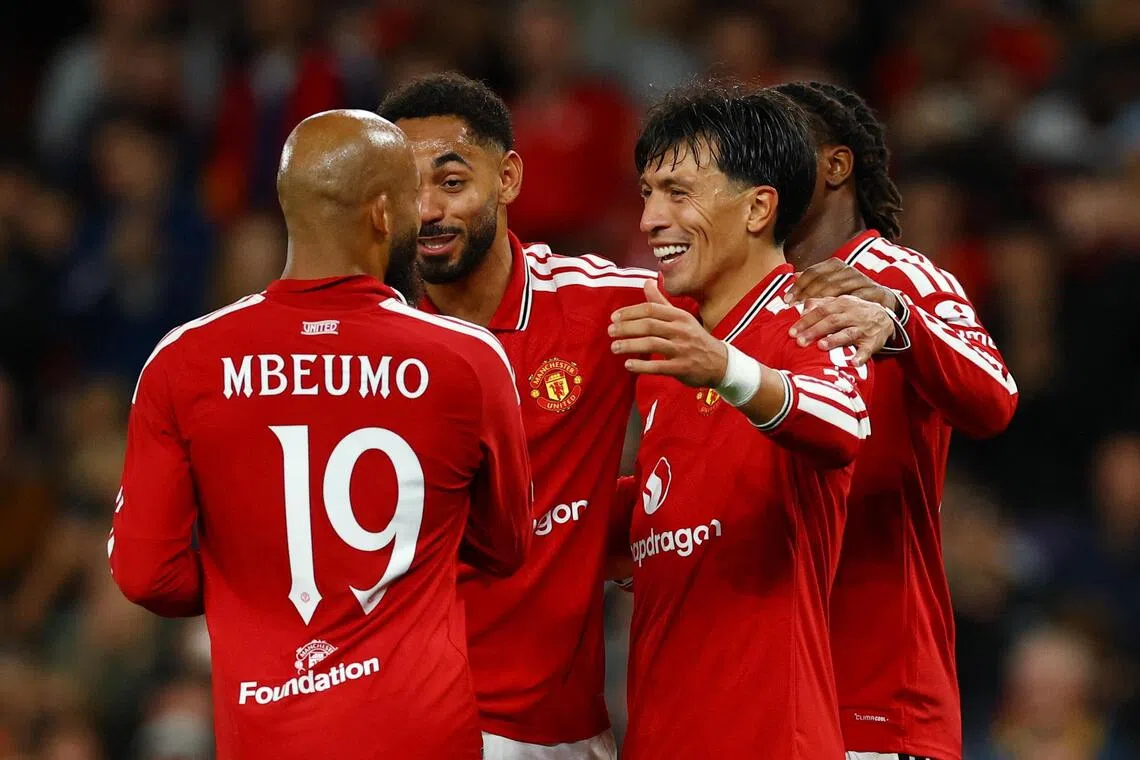 Manchester United’s Lisandro Martinez celebrates scoring their fourth and final goal with teammates.