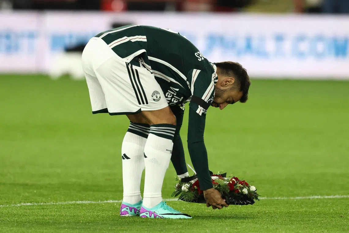 Manchester United captain Bruno Fernandes lays a floral wreath for the late Bobby Charlton before the Premier League match against Sheffield United at Bramall Lane.