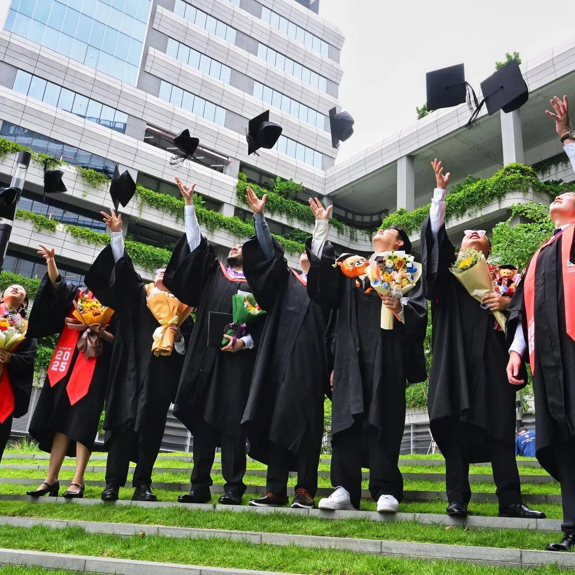 SIT graduates celebrate by tossing their mortarboards at the SIT convocation on Oct 13, 2025.