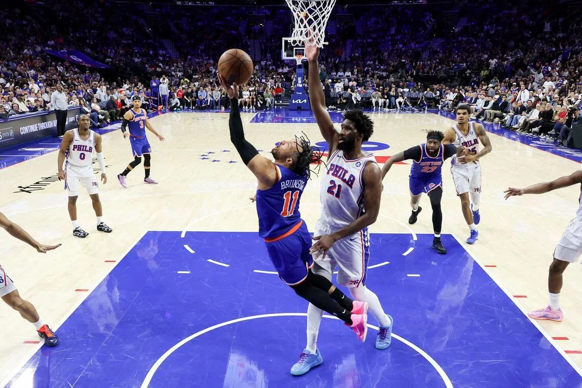 Jalen Brunson attempting a reverse lay-up against Joel Embiid of the Philadelphia 76ers during the New York Knicks' 144-114 Game 4 win at Xfinity Mobile Arena on May 10, 2026. It secured a 4-0 series sweep in the NBA Eastern Conference semi-finals.