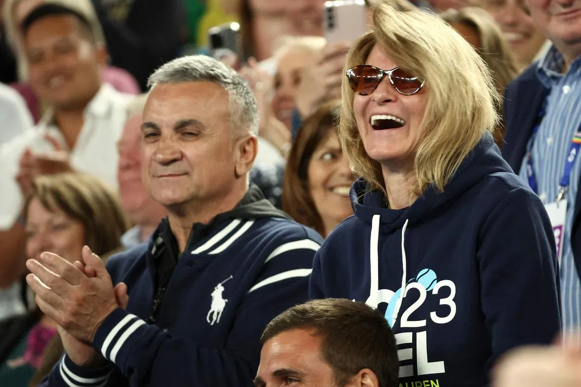 The parents of Serbia's Novak Djokovic, father Srdjan Djokovic (L) and mother Dijana Djokovic, react after he beats Russia's Andrey Rublev in the men's singles quarter-final match on day ten of the Australian Open tennis tournament in Melbourne on January 25, 2023.