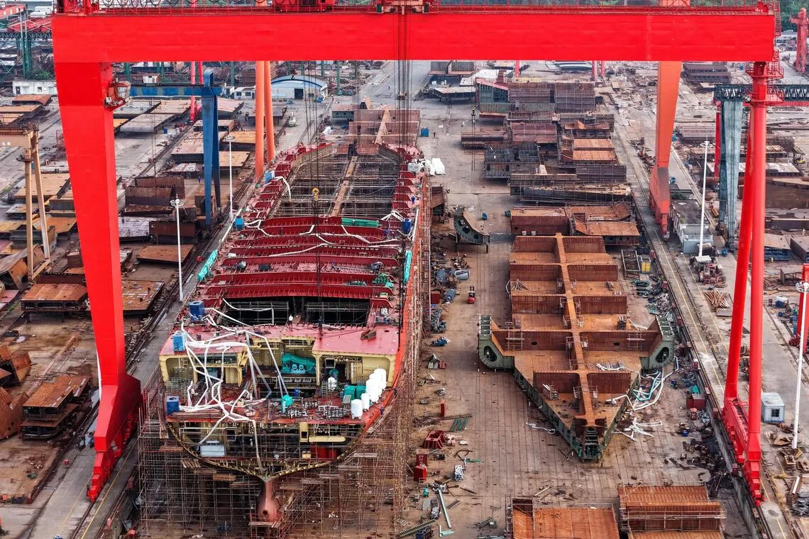 A drone view shows workers building a vessel at a shipyard in Yizheng, Jiangsu province, China August 25, 2025. cnsphoto via REUTERS   ATTENTION EDITORS - THIS IMAGE WAS PROVIDED BY A THIRD PARTY. CHINA OUT. NO COMMERCIAL OR EDITORIAL SALES IN CHINA