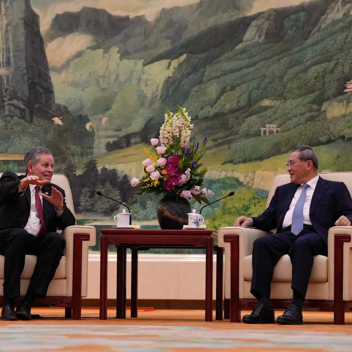 U.S. Senator Steve Daines, left, talks to Chinese Premier Li Qiang during a meeting at the Great Hall of the People, in Beijing, Thursday, May 7, 2026.     Andy Wong/Pool via REUTERS