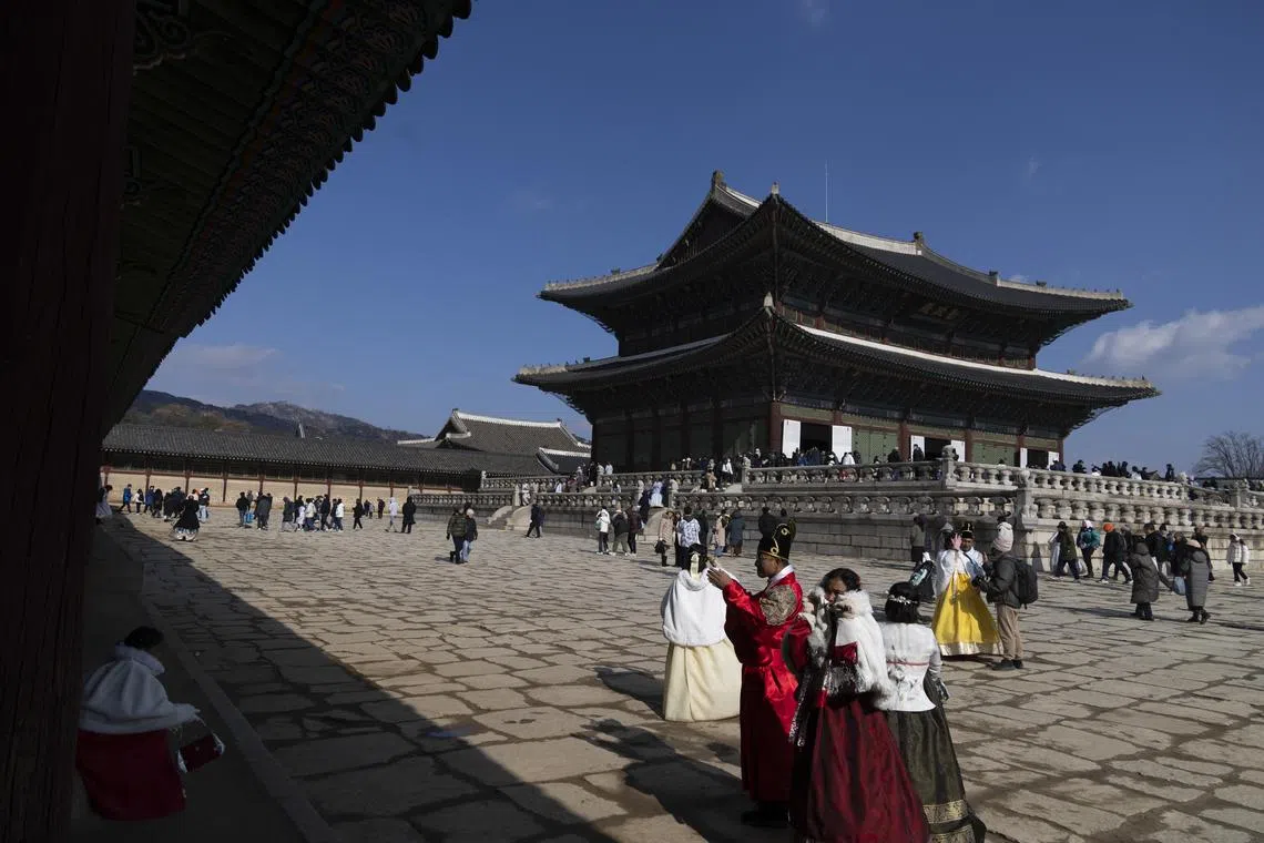 People wearing traditional Hanbok clothing at the Gyeongbokgung Palace in Seoul, South Korea, on Jan 29.
