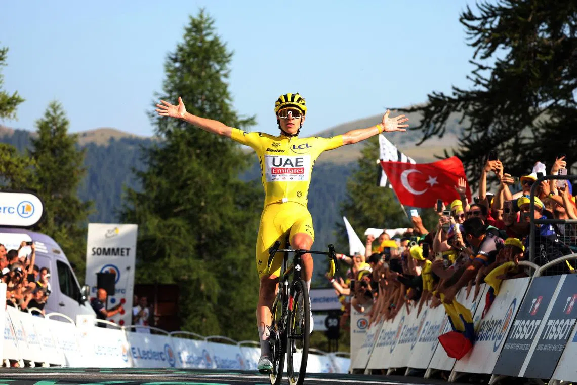 UAE Team Emirates' Tadej Pogacar wearing the yellow jersey celebrates after winning stage 20 of the Tour de France.