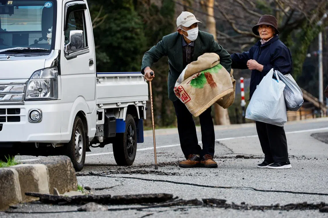 Residents in Fukamimachi, a village isolated after the earthquake, preparing as they wait for a Japan Self-Defense Forces (JSDF) personnel in Wajima, Ishikawa Prefecture, Japan, Jan 6, 2024. 