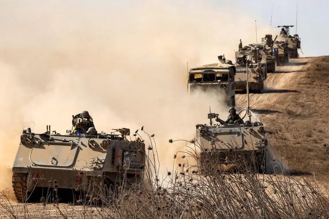 Israeli army infantry fighting vehicles deploy along the border with the Gaza Strip in southern Israel.