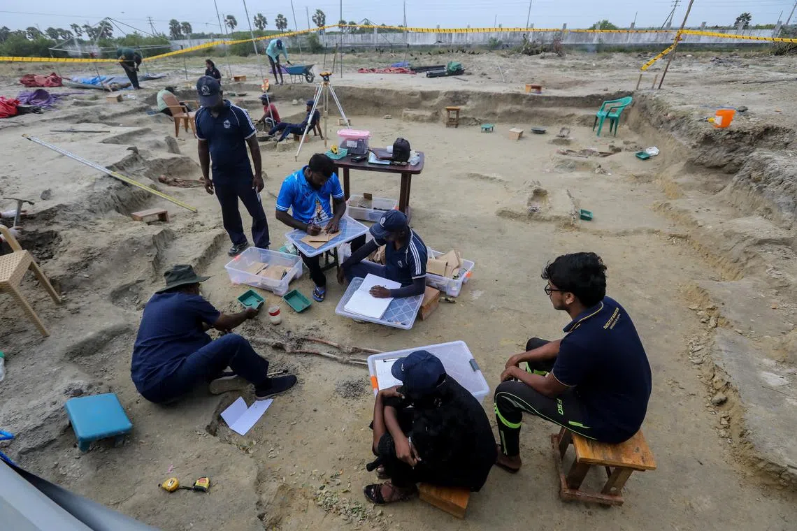 Sri Lankan forensic experts and police officers work at the Chemmani mass grave in the former war zone in Jaffna, Sri Lanka, on July 26.