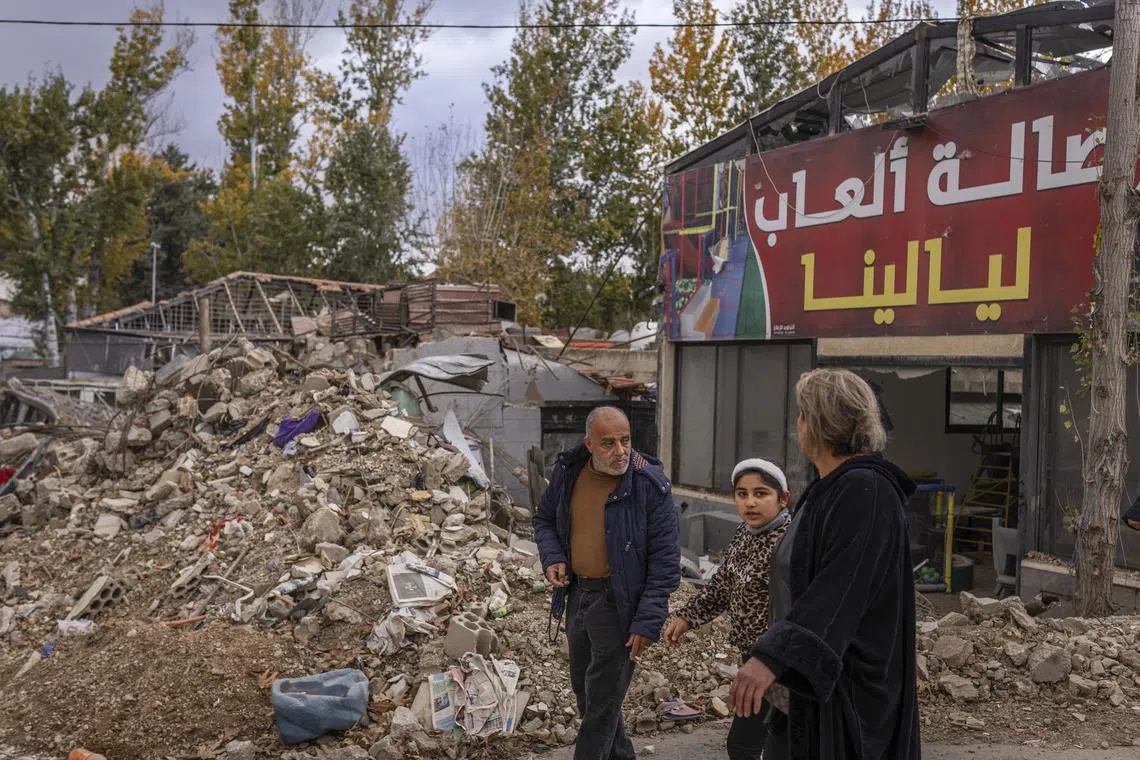 Residents walk through the debris of the ancient city of Baalbek, Lebanon, on Nov 28;