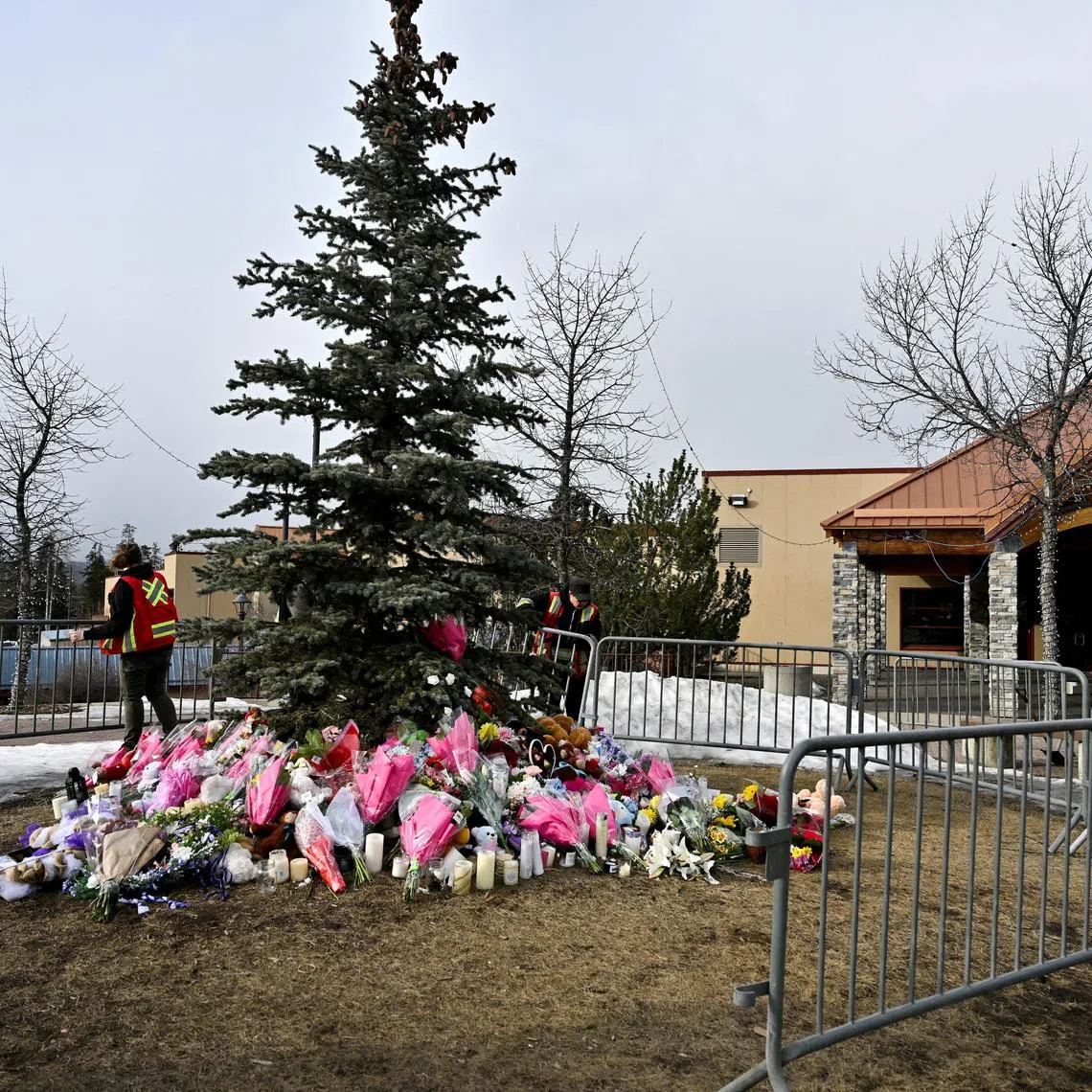 FILE PHOTO: Workers install a fence around a makeshift memorial for the victims two days after a deadly mass shooting took place at a school in the town of Tumbler Ridge, British Columbia, Canada, February 12, 2026. REUTERS/Jennifer Gauthier/File Photo
