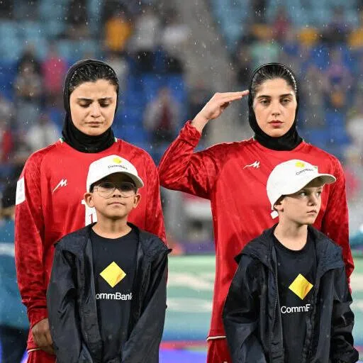 Iran players Atefeh Imani, Fatemeh Pasandideh and Sana Sadeghi react during their national anthem during the AFC Women's Asian Cup Group A match between Iran and the Philippines on the Gold Coast, Australia, on March 8.