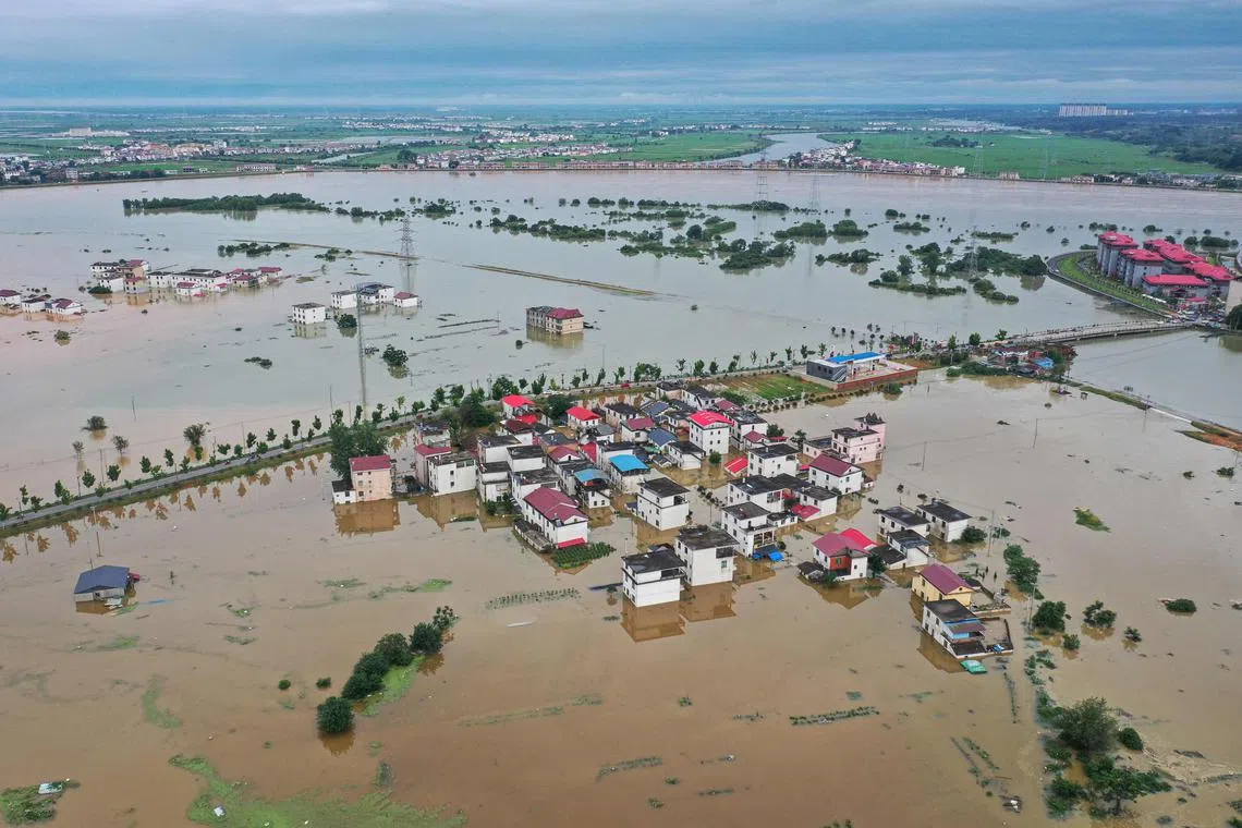 The aerial photo taken on July 2, 2024 shows submerged buildings after a flood peak in Jiujiang, in central China's Jiangxi province. More than 100,000 people have been evacuated due to heavy rain and fatal floods in southern China, with the government issuing its highest-level rainstorm warning for the affected area. (Photo by STRINGER / AFP) / China OUT