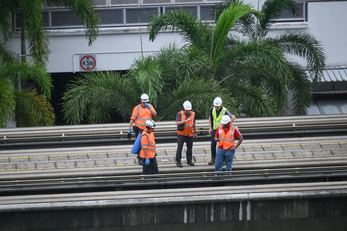 Staff inspecting the train tracks at Segar LRT station on May 18, after a man fell onto the tracks and died.