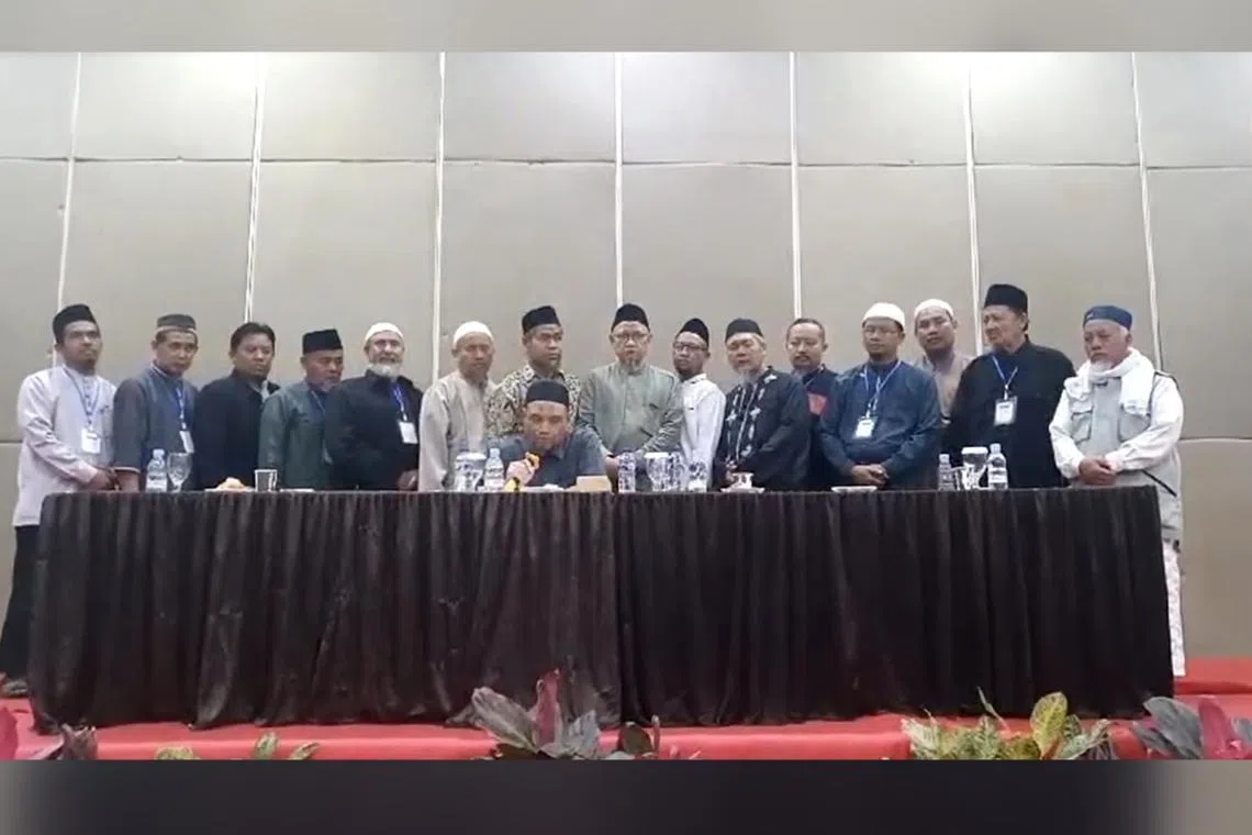 Jemaah Islamiyah in Indonesia's senior leader Abu Rusdan (seated) with other members declaring on June 30 that the terror group has been dissolved.