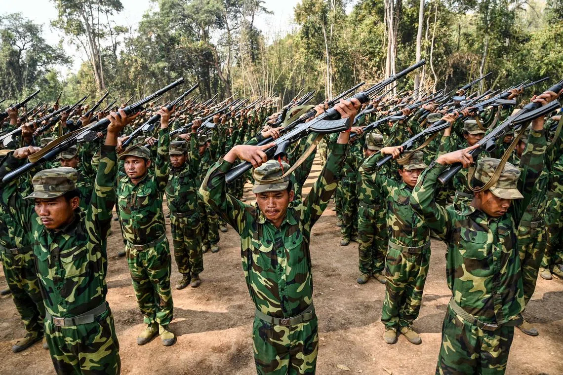 In this photo taken on March 8, 2023 members of the ethnic rebel group Ta'ang National Liberation Army (TNLA) take part in a training exercise at their base camp in the forest in Myanmar's northern Shan State.  