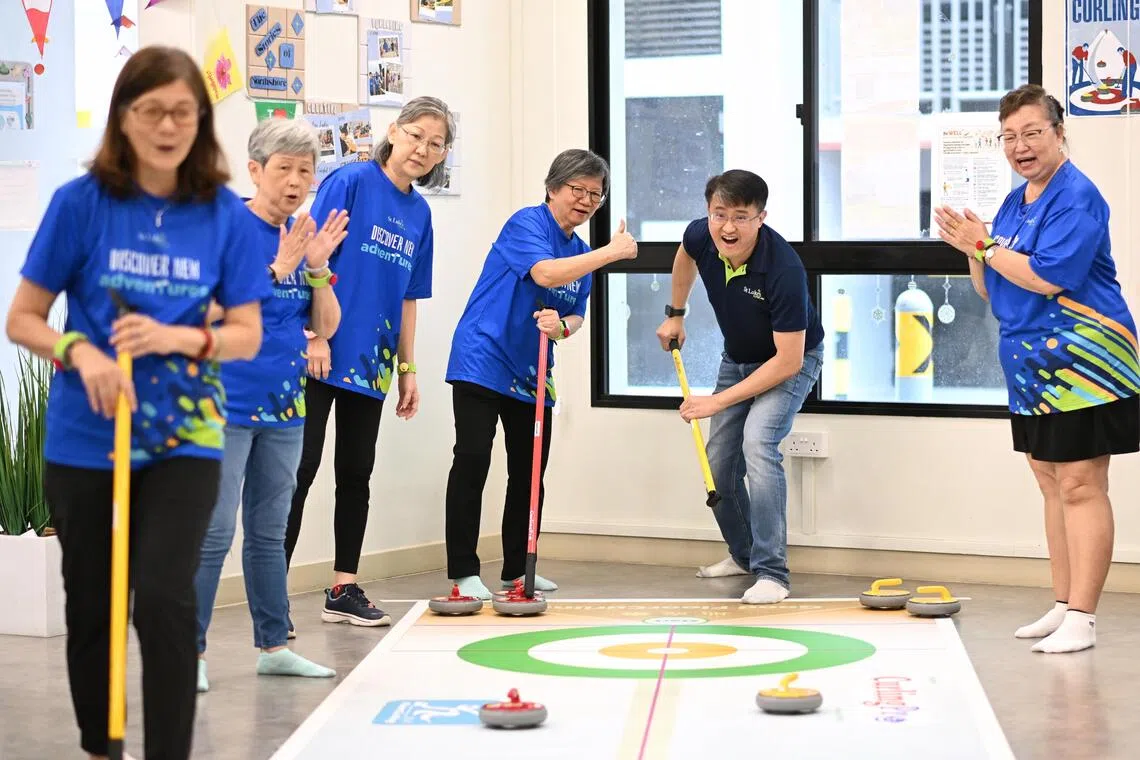 St Luke’s ElderCare CEO Kenny Tan joining seniors for a game of curling at SLEC's Active Ageing Centre (Care) at Northshore on Sept 12.