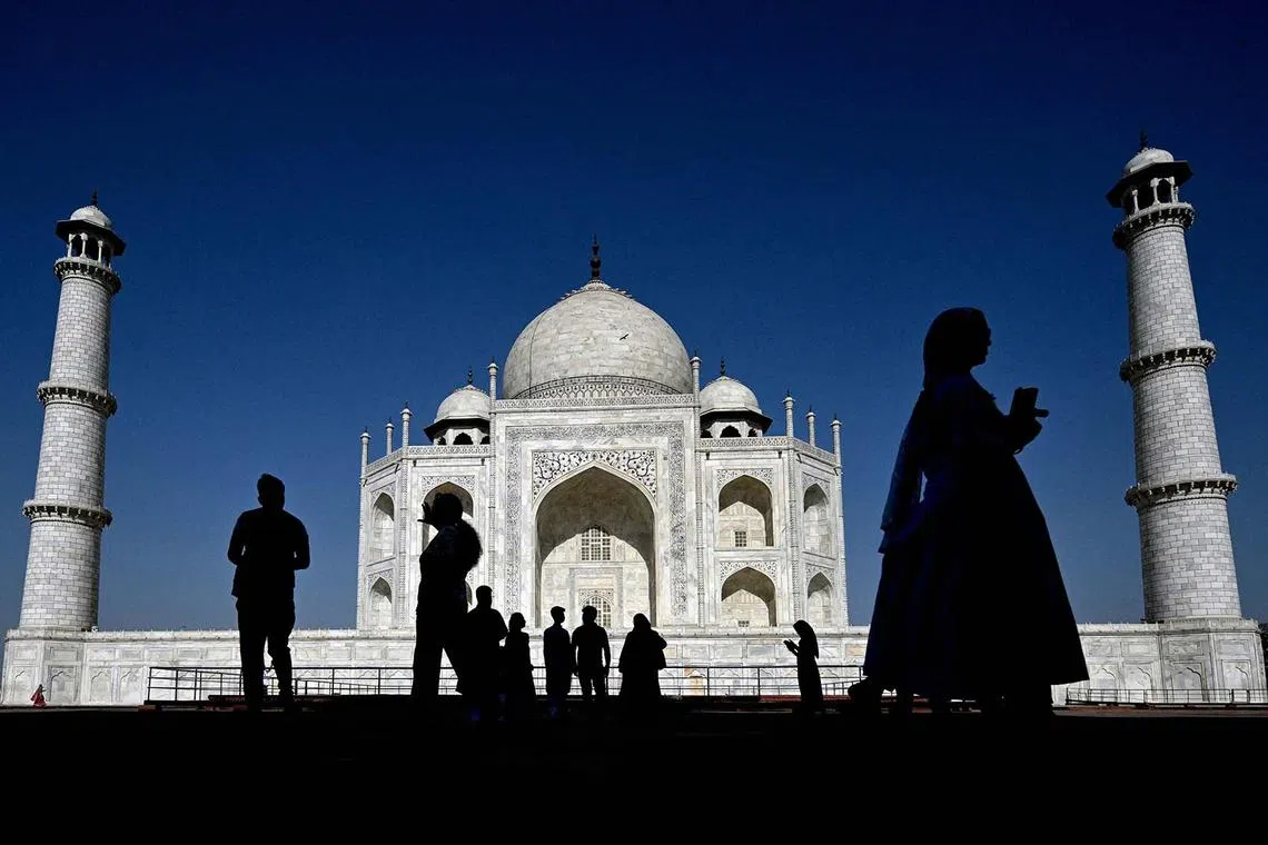 TOPSHOT - Tourists visit the Taj Mahal in Agra on April 23, 2025. (Photo by Arun SANKAR / AFP)