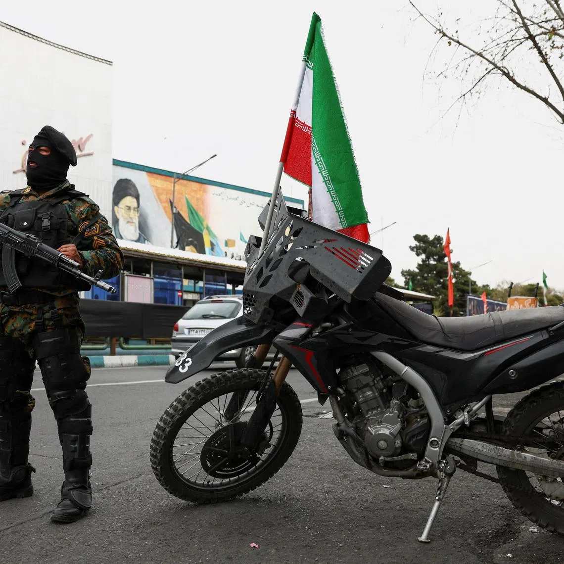 A member of a police force stands guard on a street, amid the U.S.-Israeli conflict with Iran, in Tehran, Iran, March 23, 2026. Majid Asgaripour/WANA (West Asia News Agency) via REUTERS