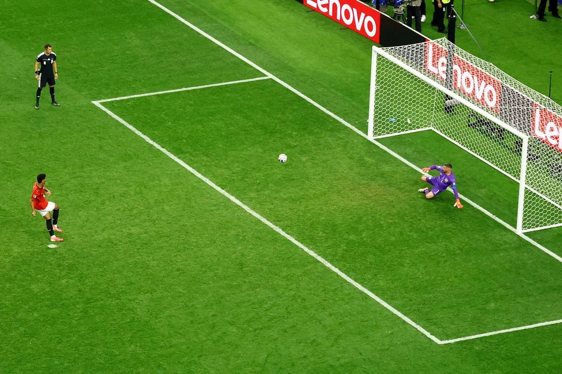 Egypt’s Hossam Abdelmaguid scores the deciding penalty against Australia’s Mathew Ryan during the penalty shoot-out to win the match as Egypt.